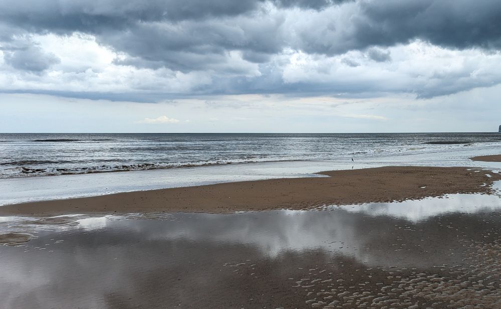 Dark clouds, calm sea, wet sand, Hunmanby 