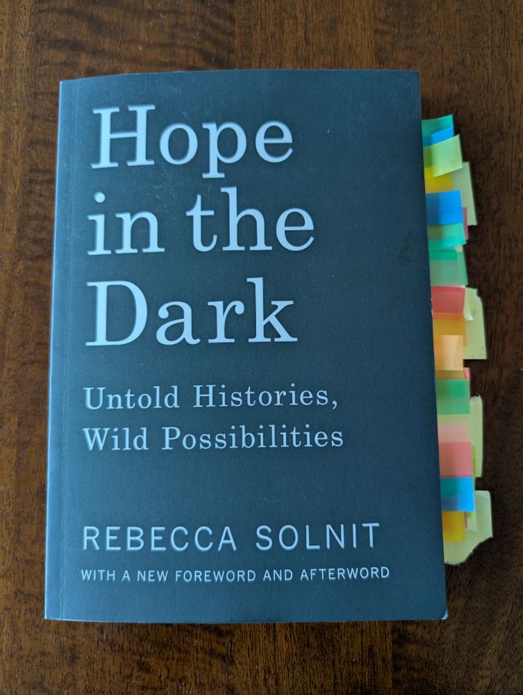 Rebecca Solnit's "Hope in the Dark" with a lot of sticky flags