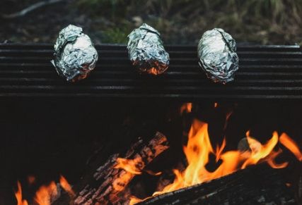Potatoes baking over the fire.
