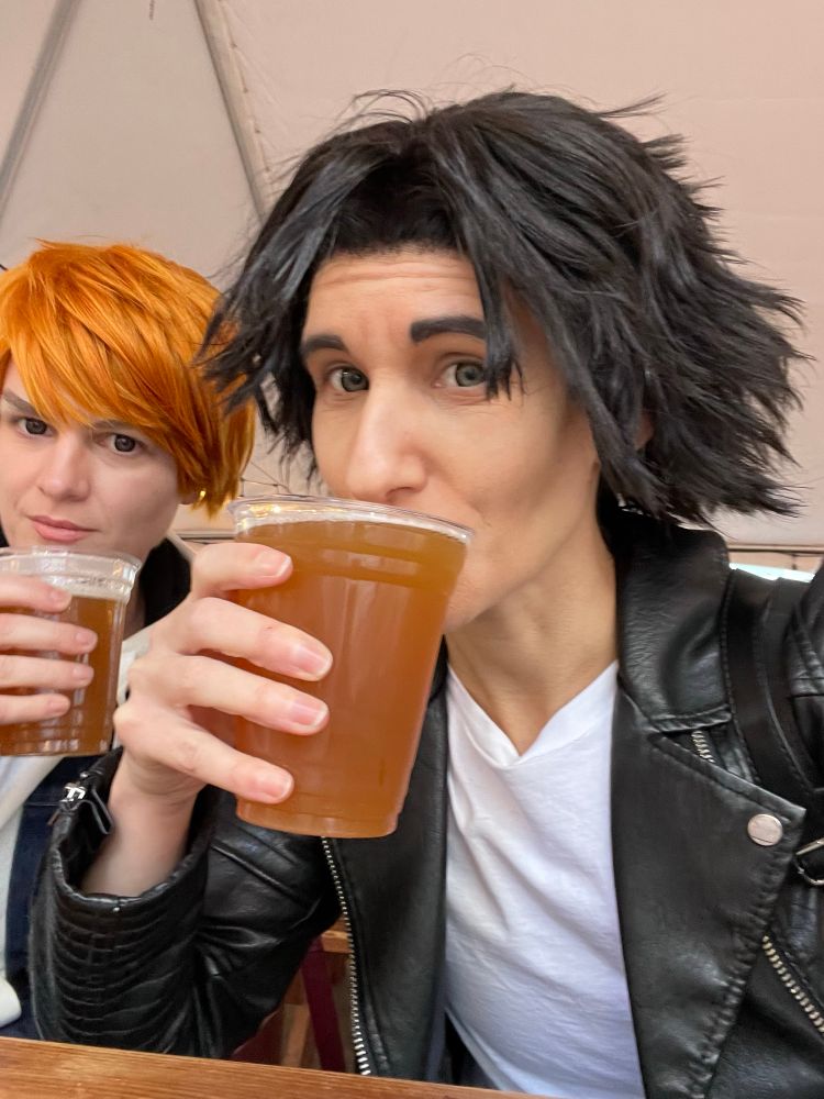 A Yagami cosplayer and a Sugiura cosplayer each with cups of beer