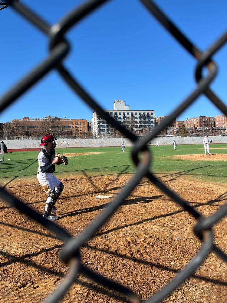 Photo of my kid playing catcher shot through the wire fence. 