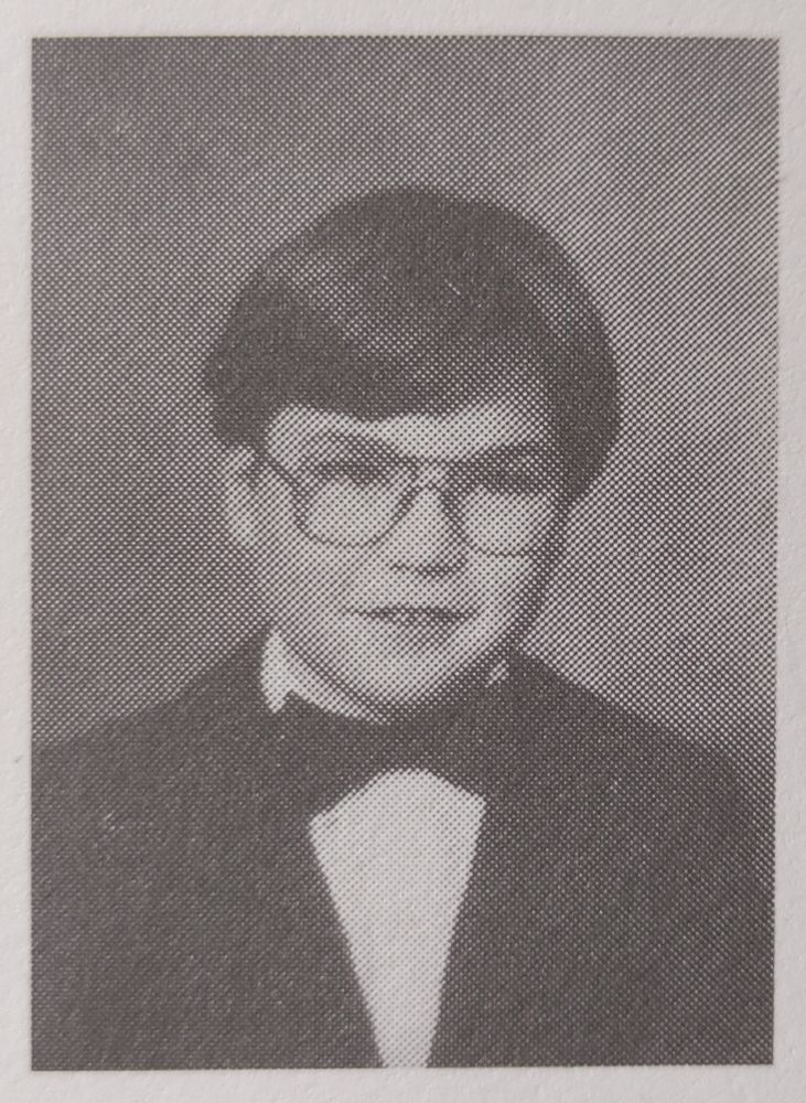 Nathaniel's second grade yearbook photo, wearing a black suit with bow tie 