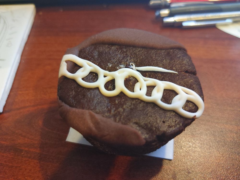 A Hostess cupcake that was missing most of its chocolate frosting