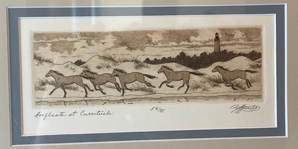 A copper plate etching titled "Hoofbeats at Currituck" shows five horses galloping, right-to-left, along a beach. Shown in the upper right of the etching is a brick lighthouse. 