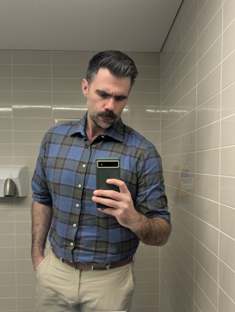 Mirror selfie in blue and green shirt
