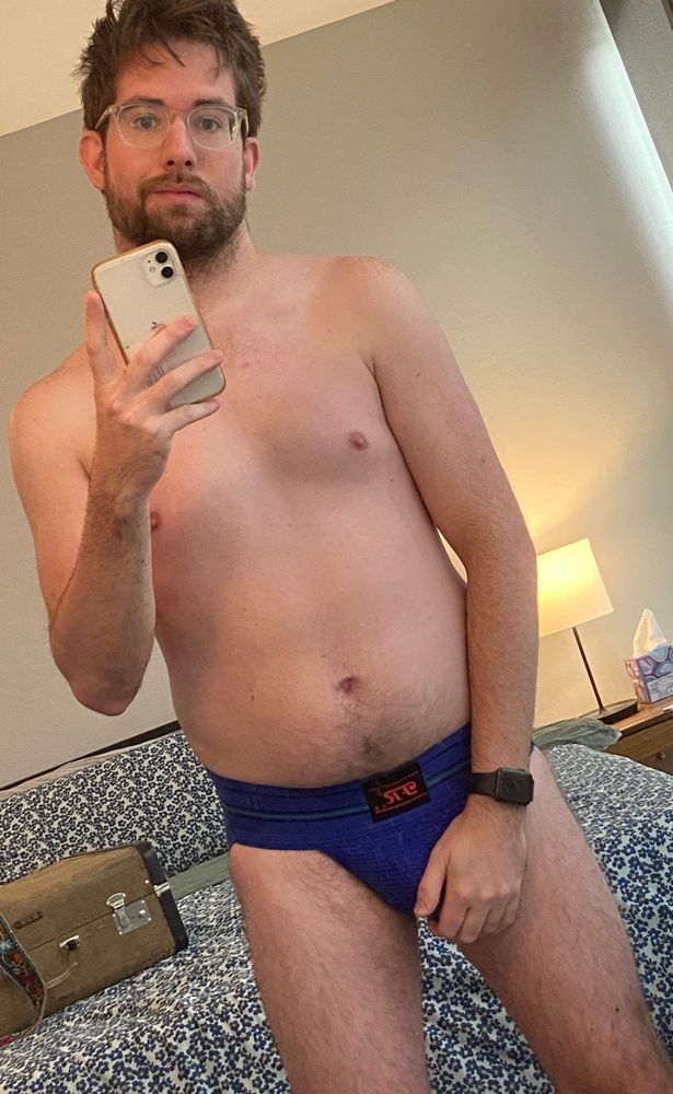 mirror selfie of Jared in a dark blue jockstrap