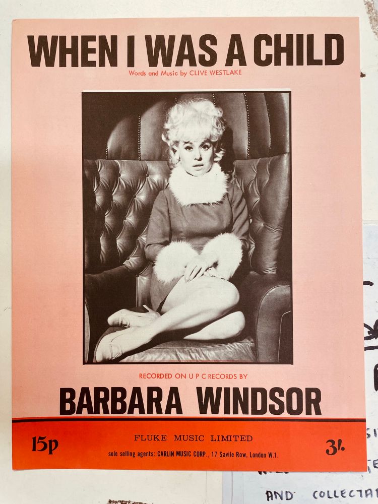WHEN I WAS A CHILD. Barbara Windsor sits on a leather chair. She has furry collar and cuffs. 