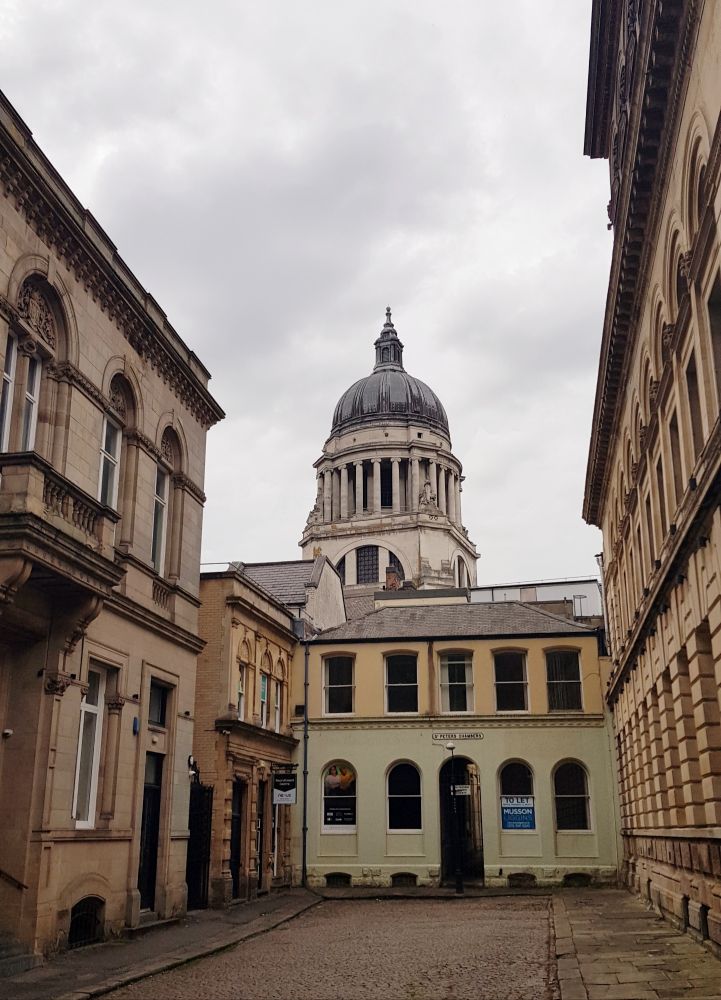Nottingham Council House rising behind  a street of classically inspired buildings.