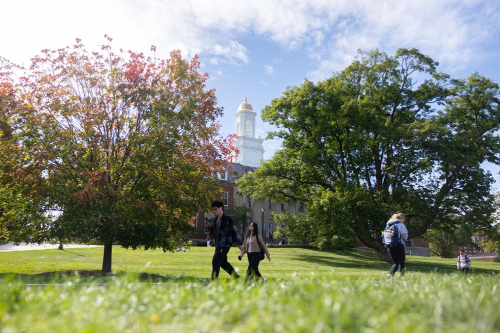 Students walk by Wilbur Cross as the leaves change colors