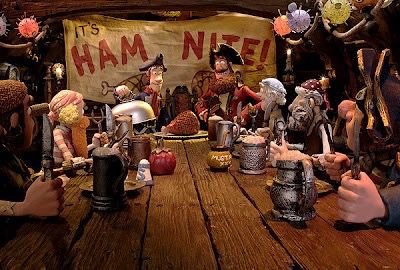 Crew gathered at a table in front of a banner reading “Ham Nite!” in the movie “The Pirates! Band of Misfits”