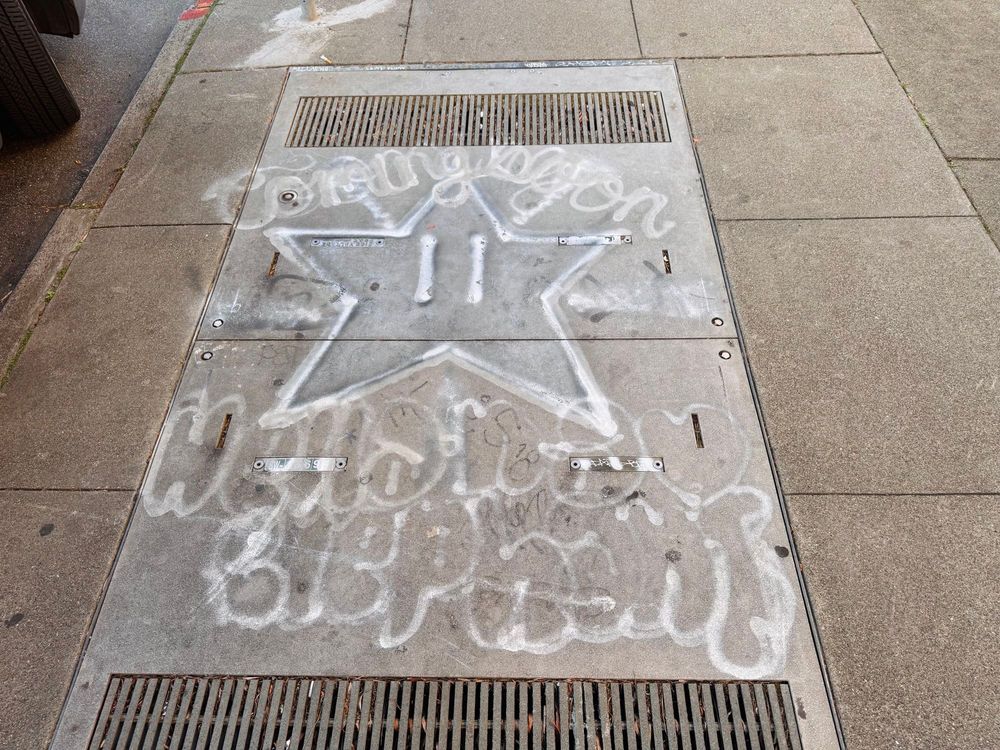 graffiti with Starman from Mario Kart and bubble letters that kinda looks like “Coming soon Hella Naw Elephant”