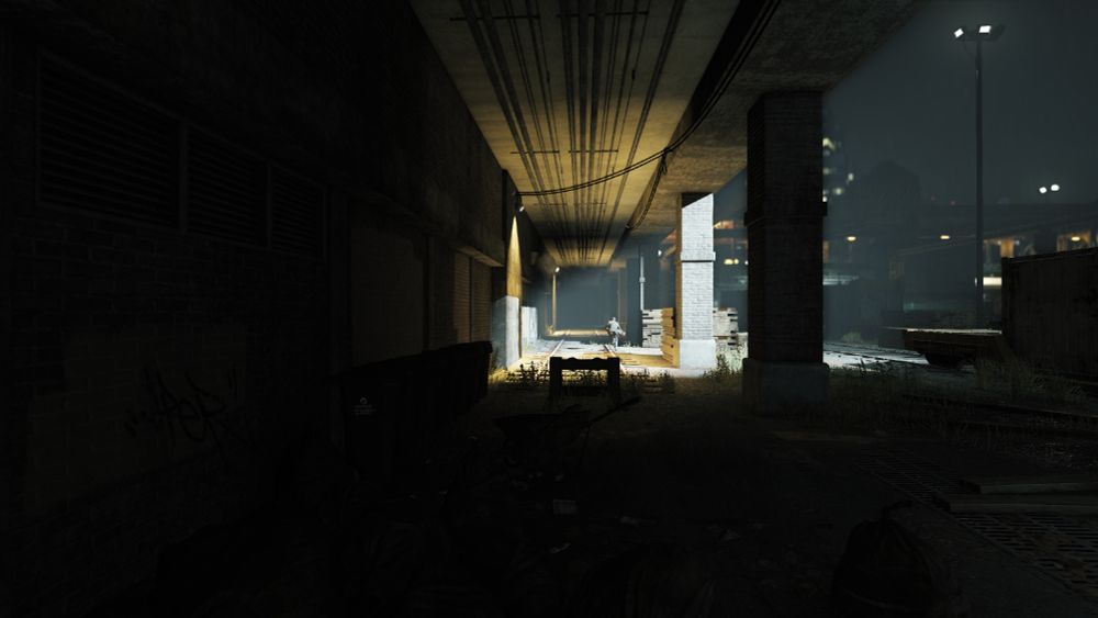 Aiden Pierce running into a train tunnel covered by a helicopter spotlight
