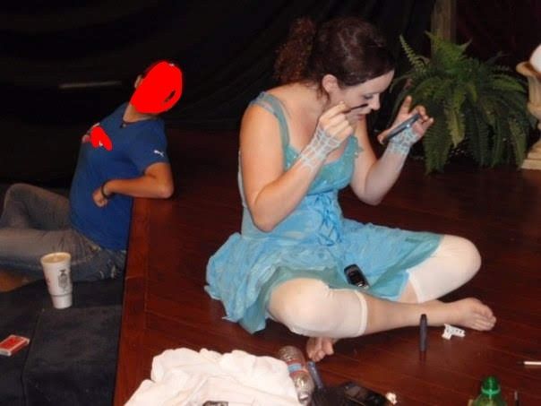 Photo of College Emily sitting on a stage in a blue fairy costume doing my makeup