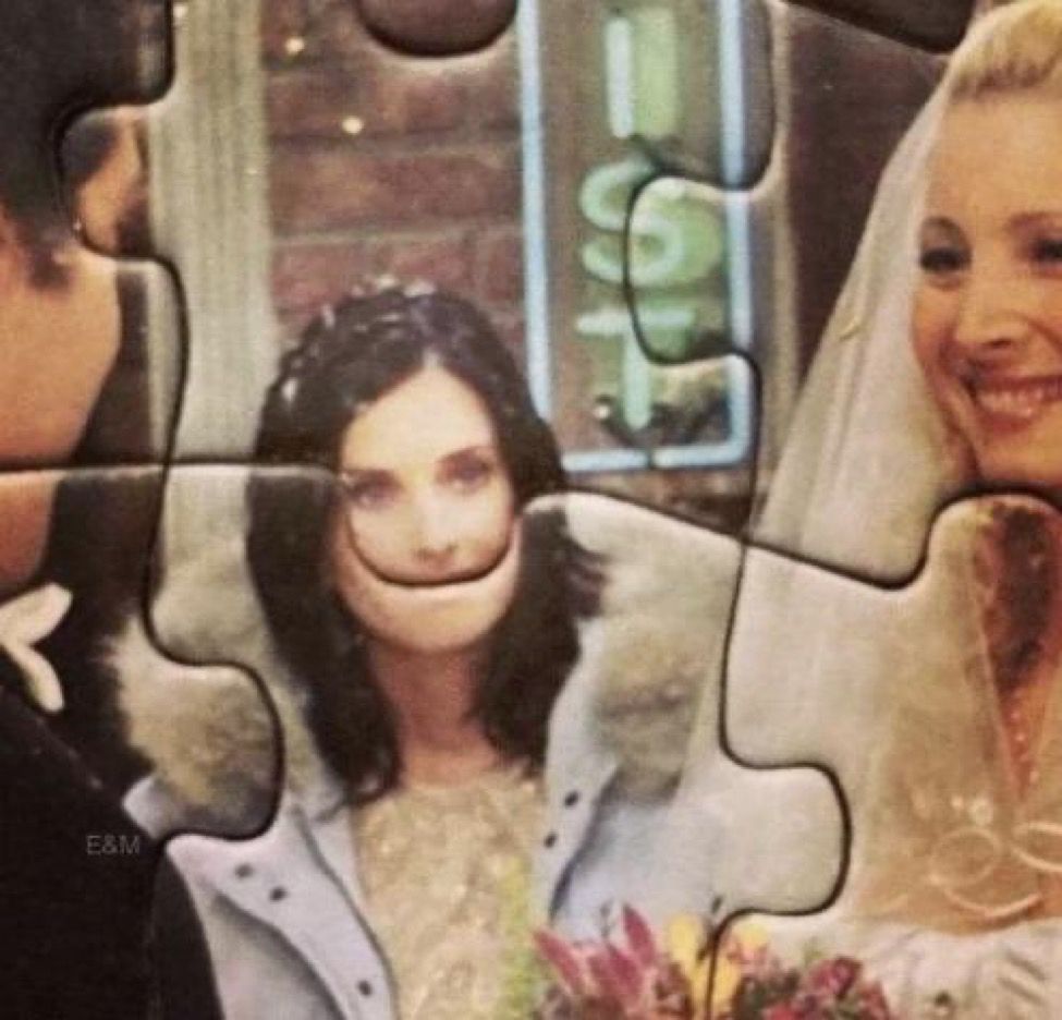 courtney cox as monica in friends, and it’s a puzzle of a scene from friends but the piece intersects with courtney’s mouth making it look huge and weird 