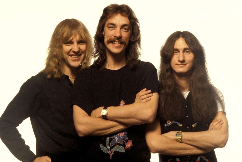 A photo of the Canadian prog-rock band Rush: Alex Lifeson, Neil Peart (+2020), Geddy Lee.