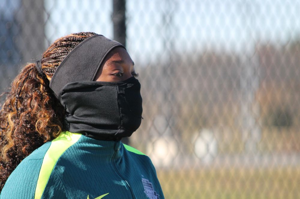 Kysha Sylla wearing a black head band and face covering