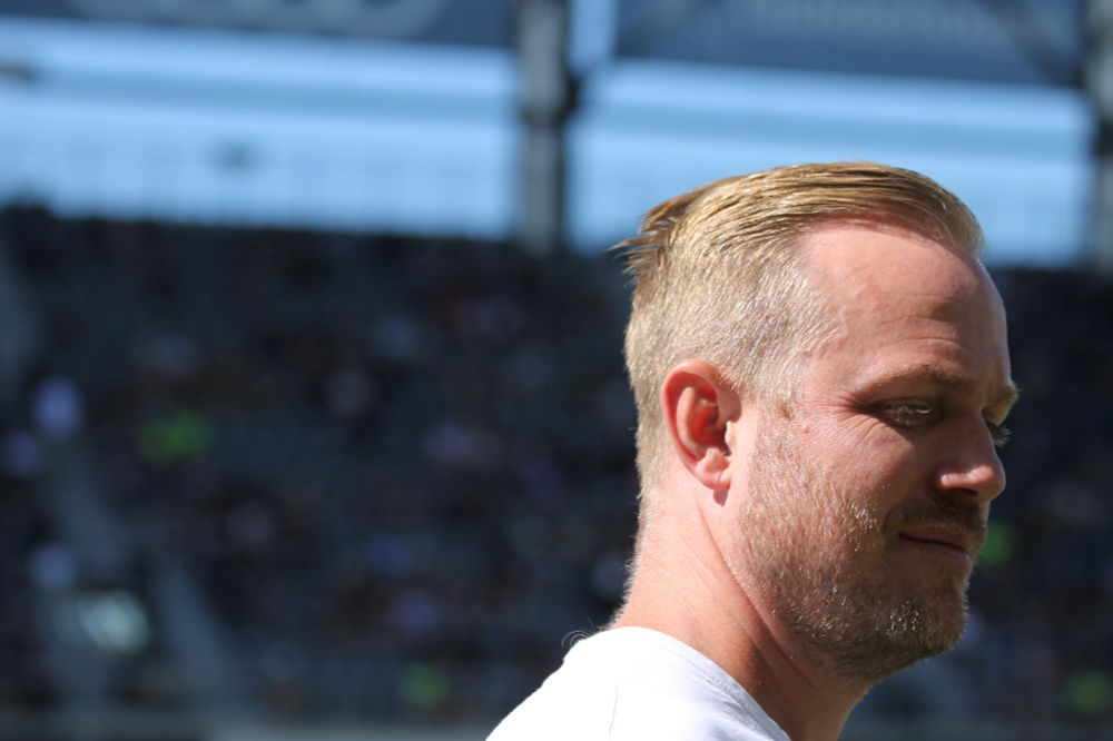 A close-up shot of San Diego Wave head coach Jonas Eidevall. He has blonde hair, a neutral expression and his head is in the right third of the shot.