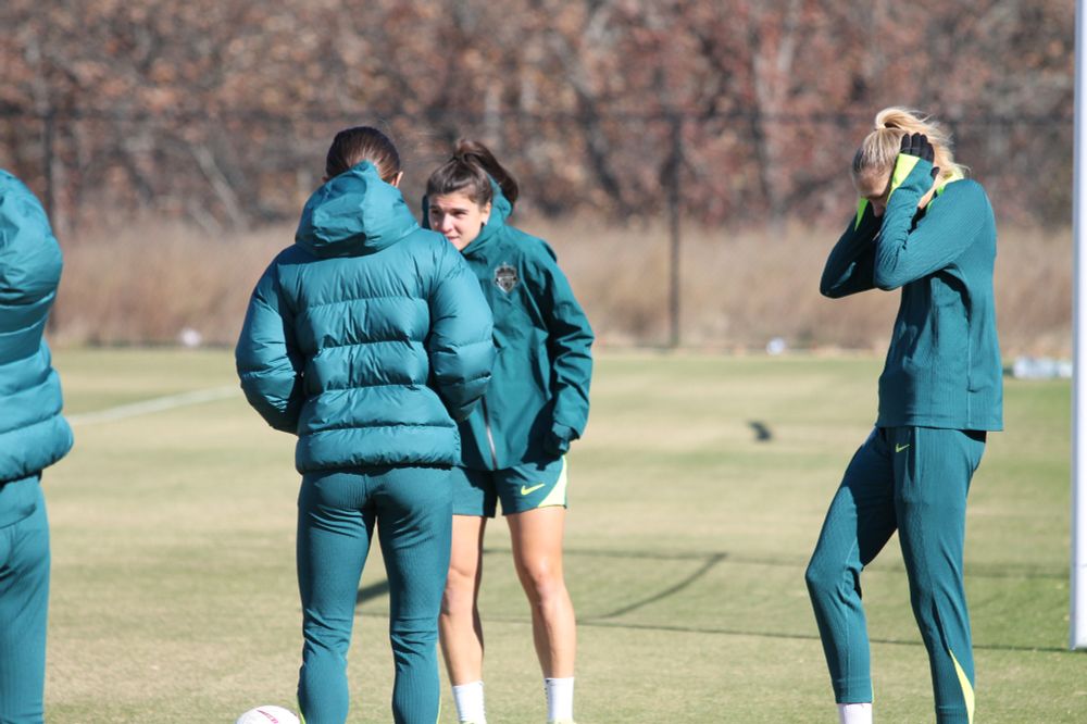 Esme Morgan, at right, covering her ears with her gloved hands, seemingly pained by the cold
