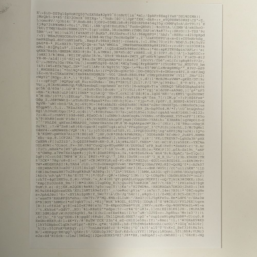 A page of printer page with random alphanumeric characters filling the margins.