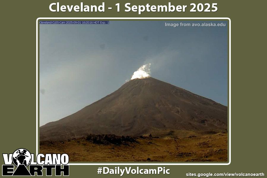 Webcam image of Cleveland. A small cloud of white surround the very summit of the snow-free volcano.