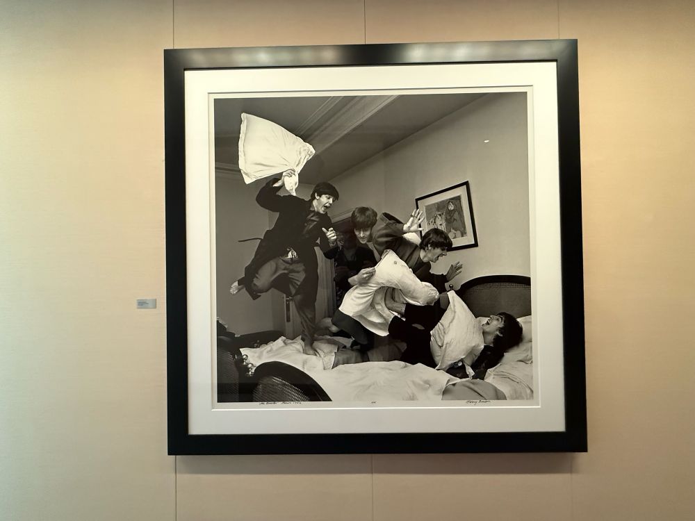 Photo of The Beatles having a pillow fight by Harry Benson exhibited at Hearst Tower