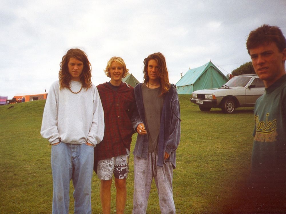 A photograph of three hippy looking young lads on a campsite taken in the 90’s. 