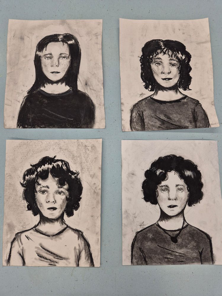 Four charcoal portraits of women.