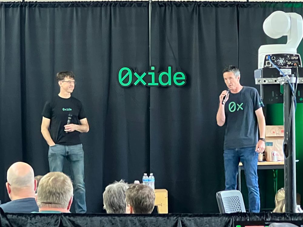 Oxide leadership on stage presenting at an internal Oxide conference.