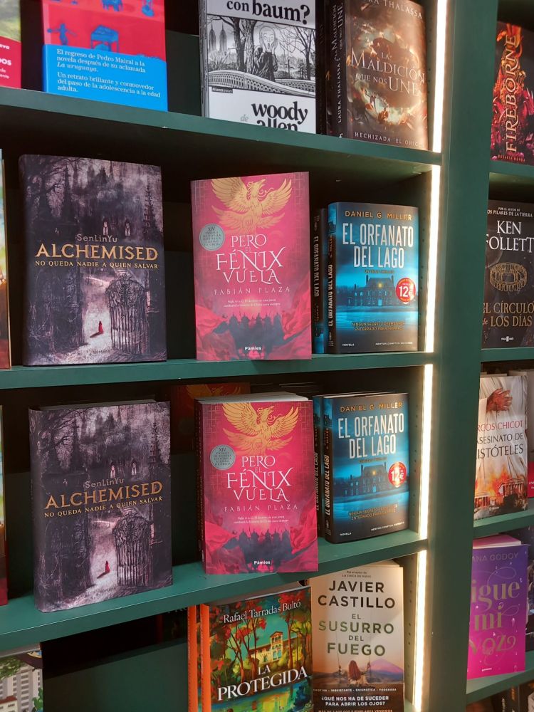 Estantería con libros, entre ellos varios ejemplares de "Pero el fénix vuela".