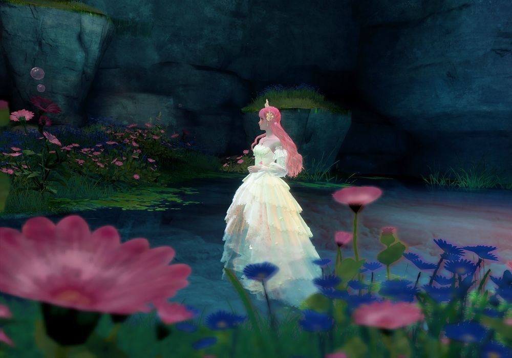 Nikki, framed by flowers, standing in a spring. She's wearing a pastel yellow dress and has long pink hair. 