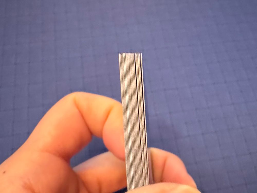 Close up of stacked cards on the side. You can see two card edges are white-ish and standout
