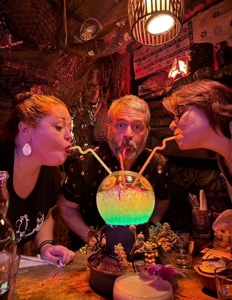 Sharing tiki drinks with two lovely ladies. Three straws, one giant bowl of booze. 