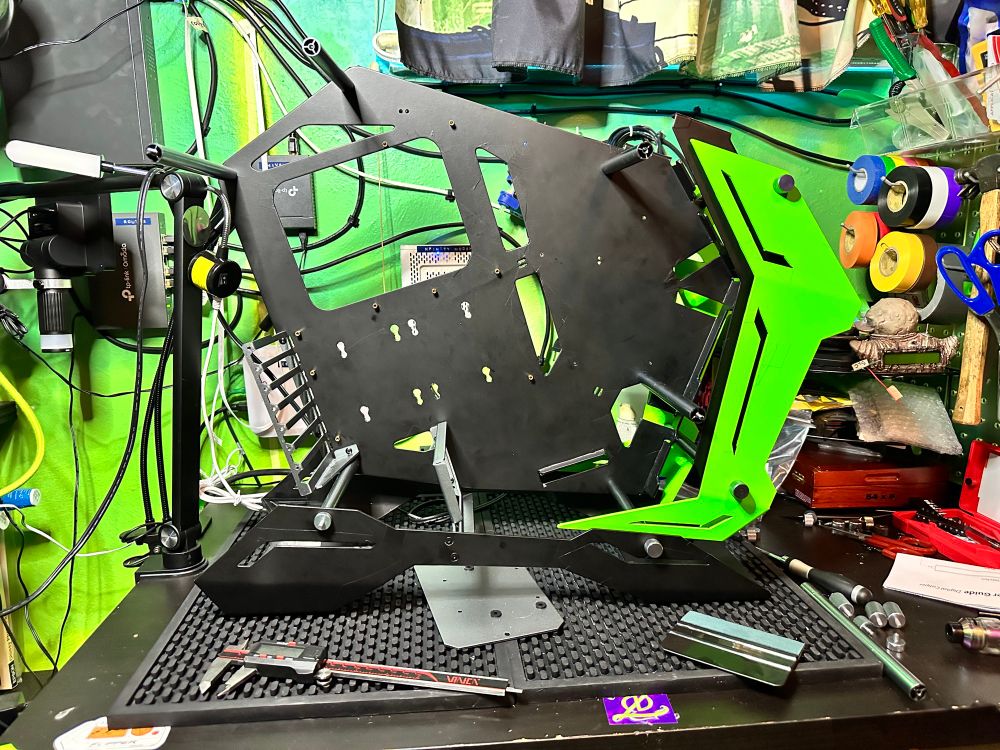 Jonsbo MOD3 partially assembled PC case. Vinyl wrapped in black and green.