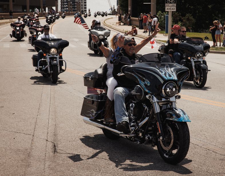 Middle-aged and older riders on Harley-Davidson motorcycles in a group ride at the Harley Homecoming event in Milwaukee