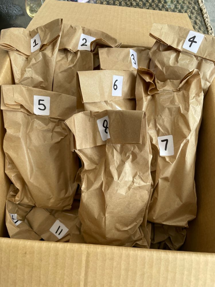 Box containing 24 beers in numbered brown paper bags so as to be a Christmas Advemt calendar 
