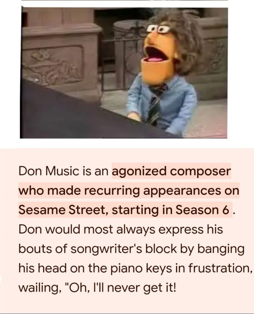 An orange Muppet with glasses and a tie sits at a piano, looking despairing