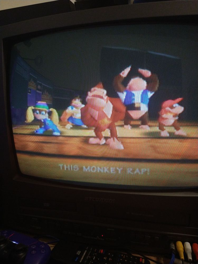 CRT tv feed from donkey kong 64 and its characters on a stage 