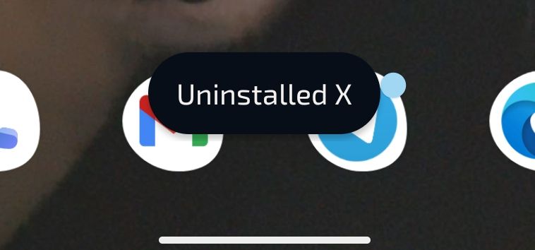 Screenshot of user's home screen featuring system notification reading "Uninstalled X"
