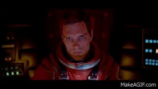 Scene from the movie "2001" where Dave is asking the computer HAL to open the pod bay doors. First focuses on Dave's face asking the question. Then cuts to the empty internal airlock room, where there is no one left to help Dave.