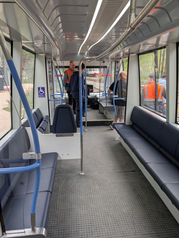 The interior of the Coventry Light Rail Veichle, with seats, tactile flooring and a driver cab