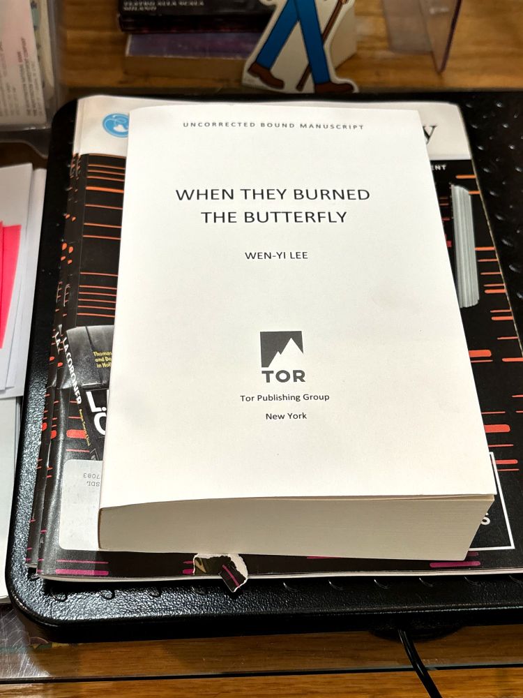 Advanced Bound Manuscript of When They Burned the Butterfly by Wen-Yi Lee. There is no cover. It's just white with the Tor Publishing Group logo of a mountain on it.