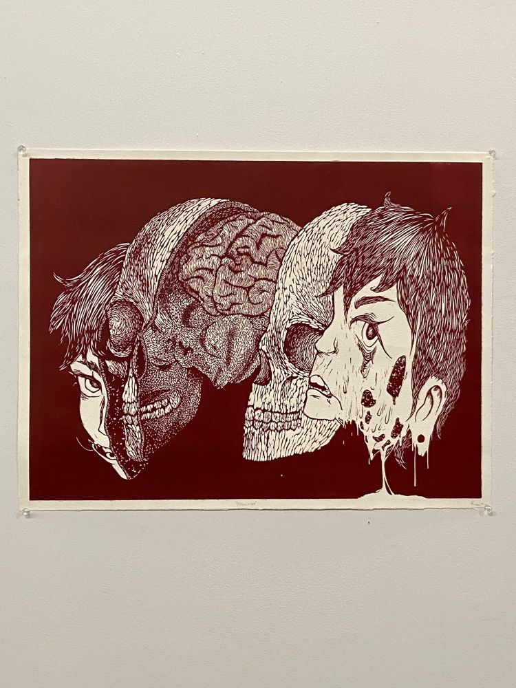 A one layer horizontal lincout that features a split face. there are several layers in the split, with skin on the outside, skull a layer inside, and a brain in the very center. on the right face, the skin is melting off. The left face features a hook through the mouth 