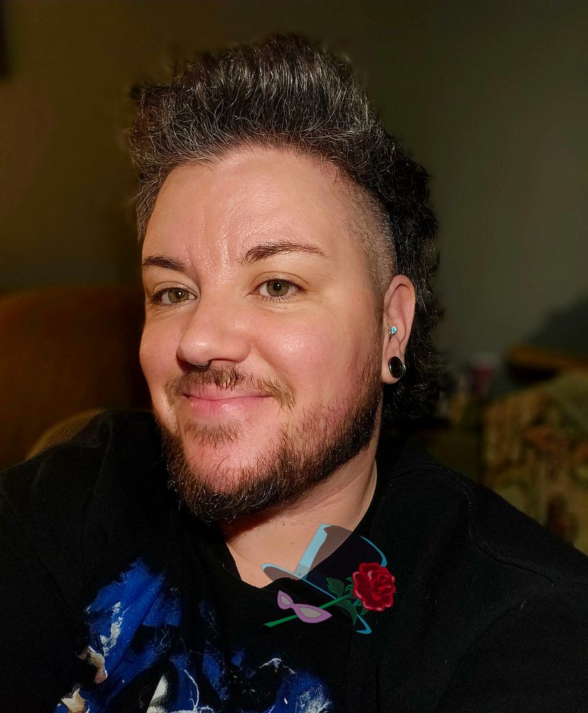 alfie smiling at the camera in a black tshirt