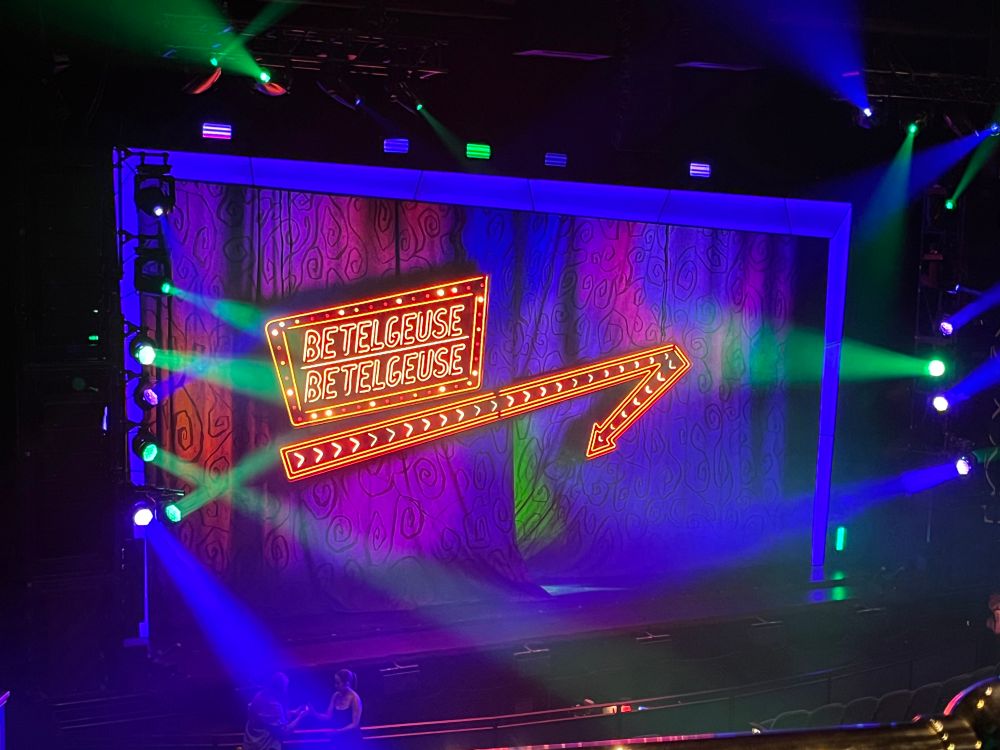 View of the stage of the Ed Mirvish theatre. Neon sign says Betelgeuse Betelgeuse. 