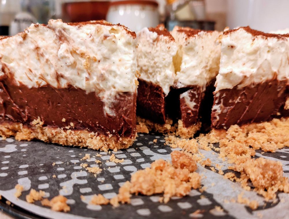 Chocolate cream pie with graham cracker crust and whipped cream topping.