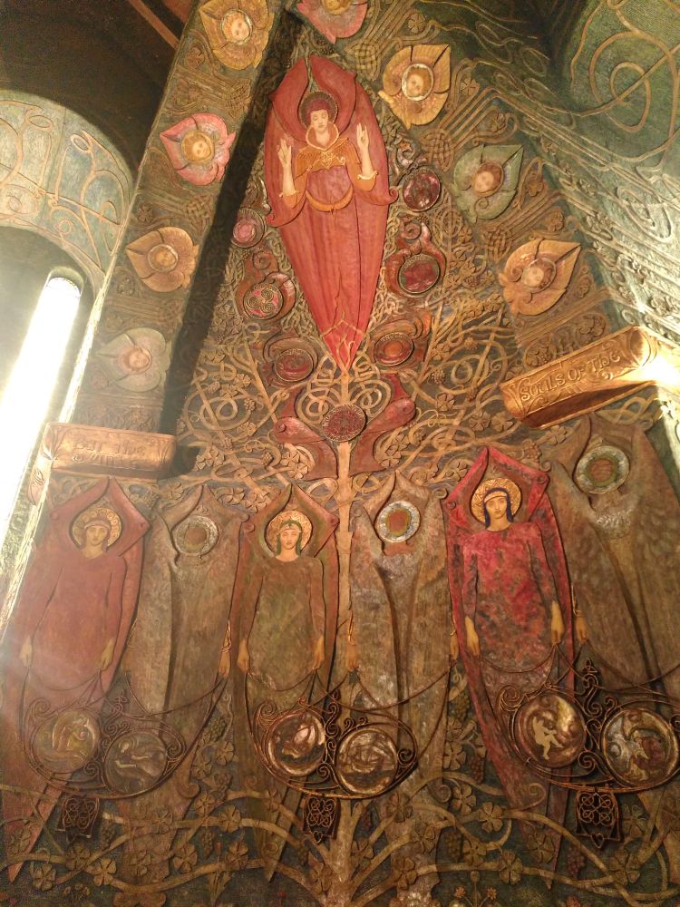 Another wider view - an angel in crimson red is at the top, with three other people below. Loads of coiling vines representing the tree of life.