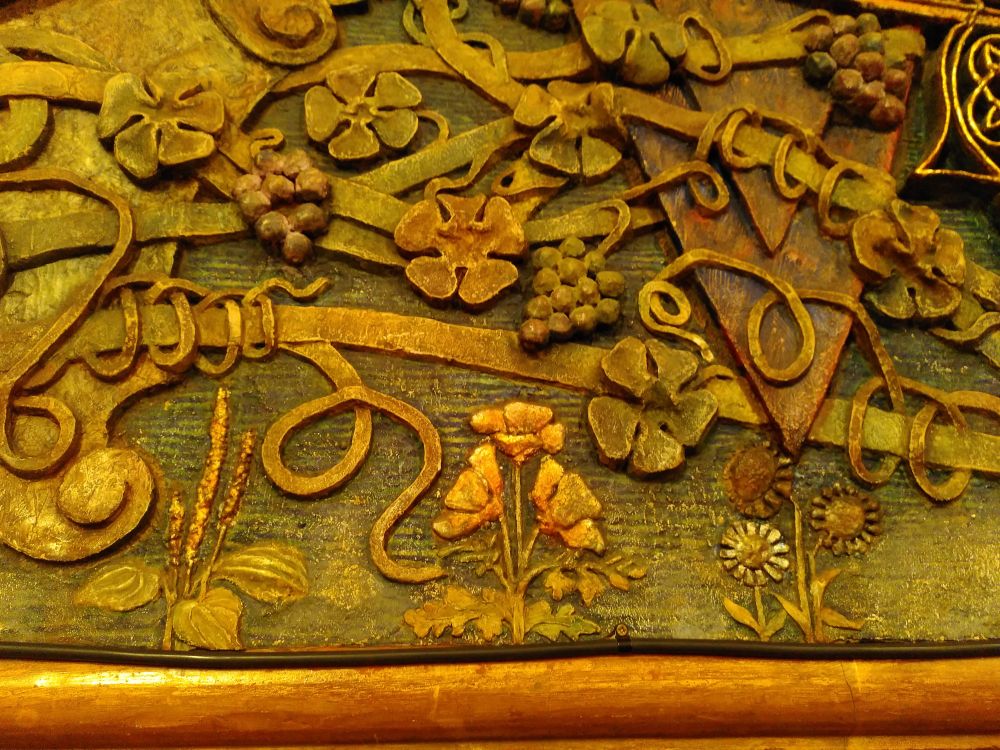 Detail of flowing 3D relief plasterwork, with vine leaves and grapes, flowers growing. Like Celtic knotwork.