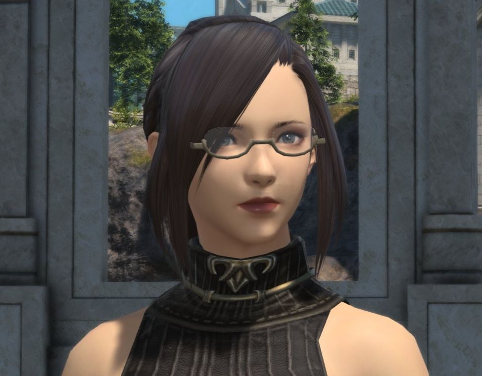 A hyur woman pre the FFXIV model update. She has brown hair framing her face and grey eyes. She wear brass glasses.