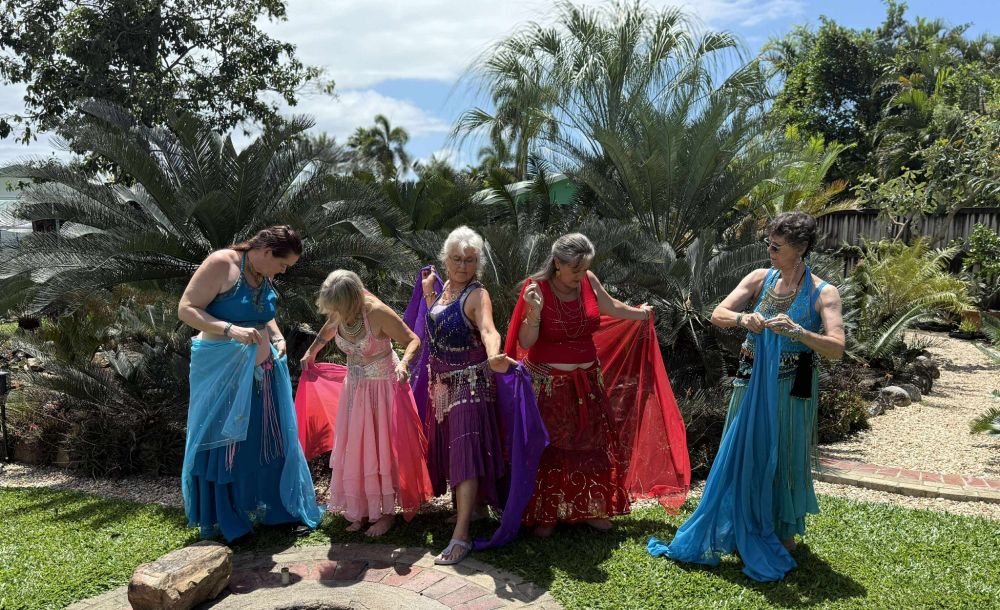 A shot of the ladies taken without their knowledge. They are all adjusting their costumes. It conveys their easy friendship and confidence with each other 