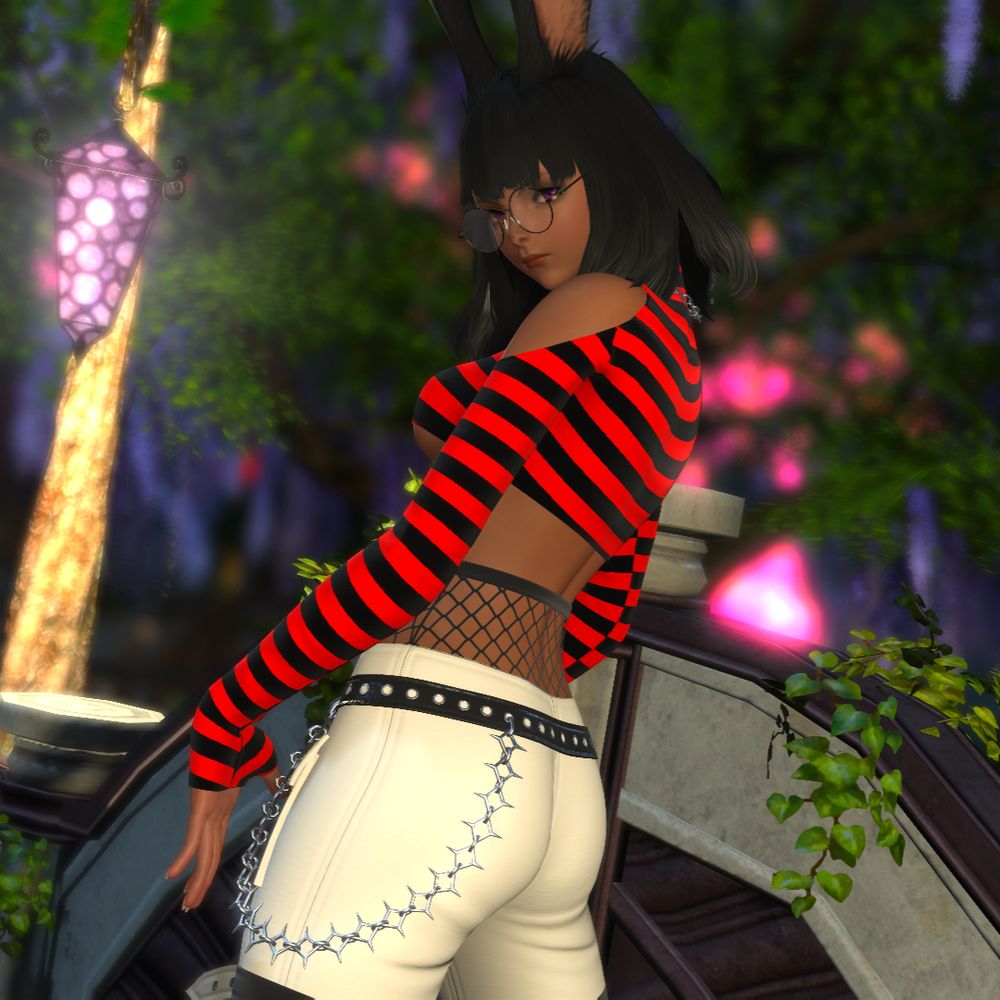 dark skinned bun girl staring back at the screen with her back turned